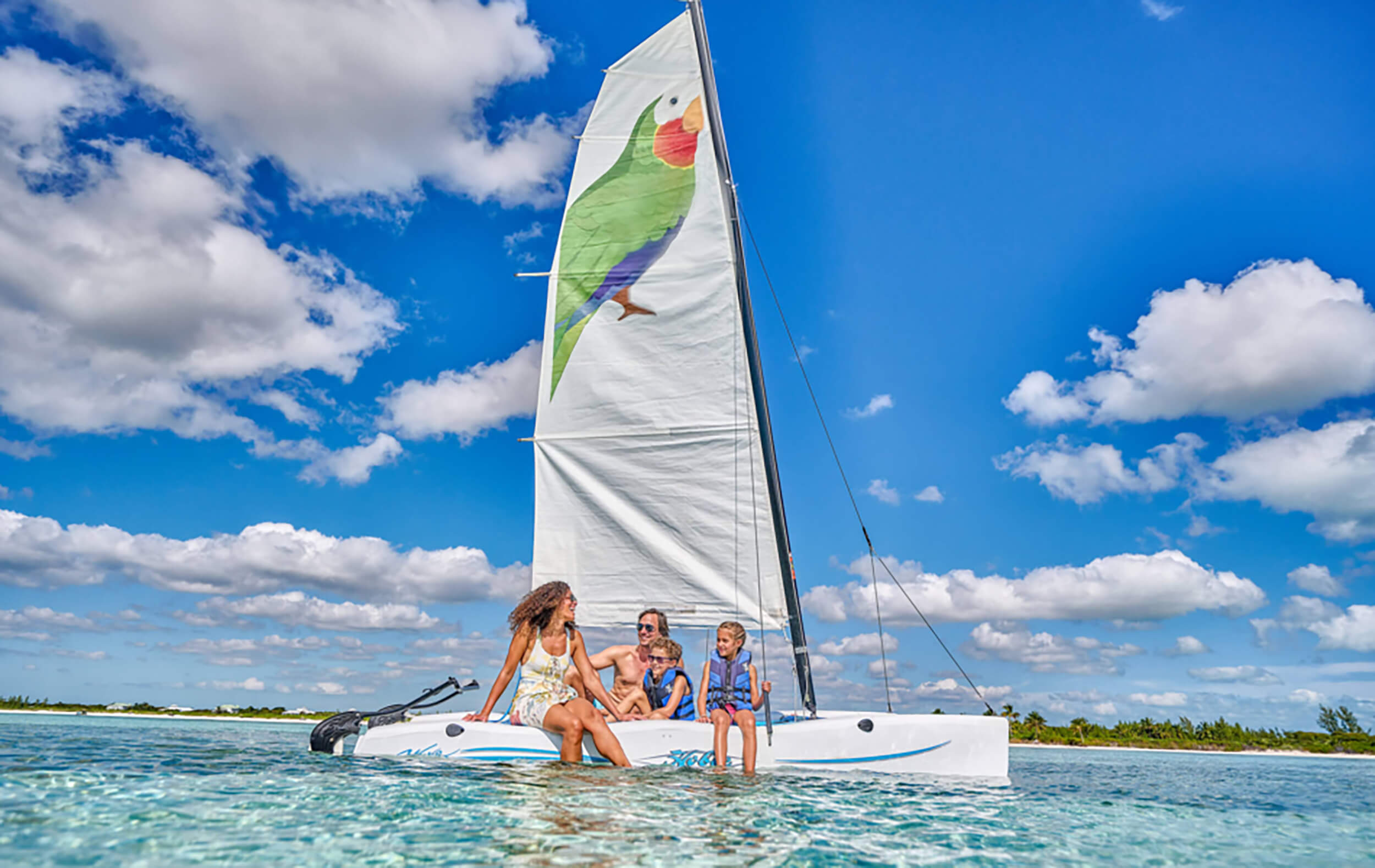 People on an Abaco Club sailboat enjoying coastal weather and lifestyle