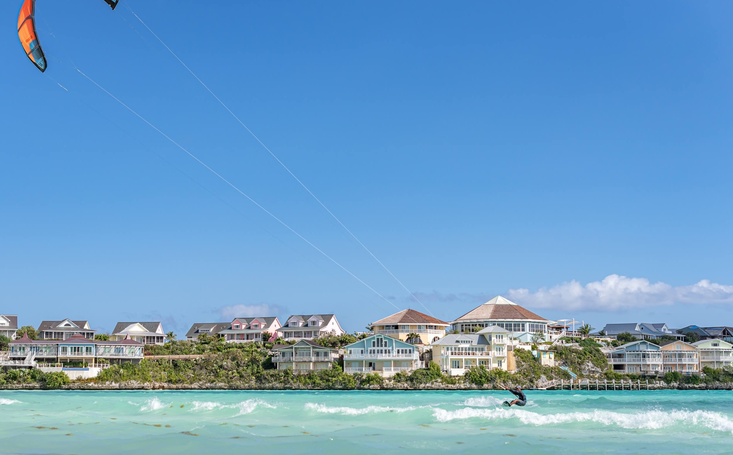 A person kite surfing enjoying exclusive coastal lifestyle at The Abaco Club