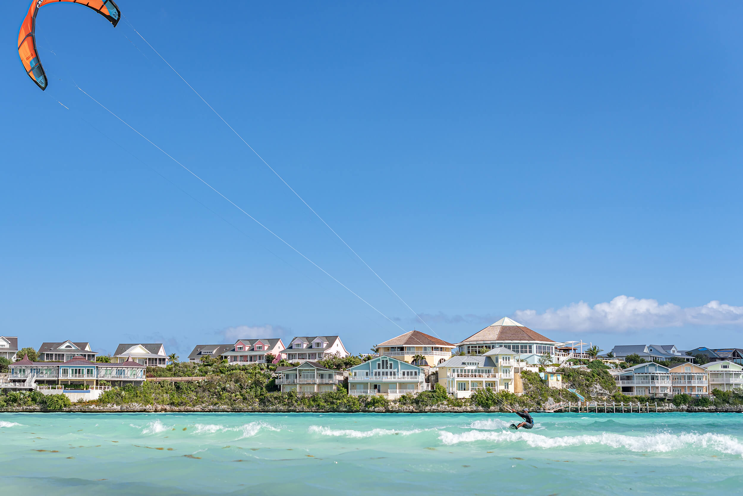 A person kite surfing enjoying exclusive coastal lifestyle at The Abaco Club