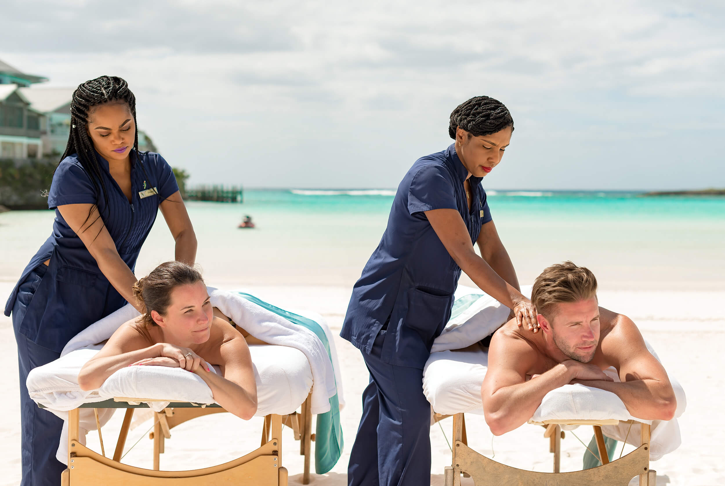 A couple receiving a beach massage at The Abaco Club