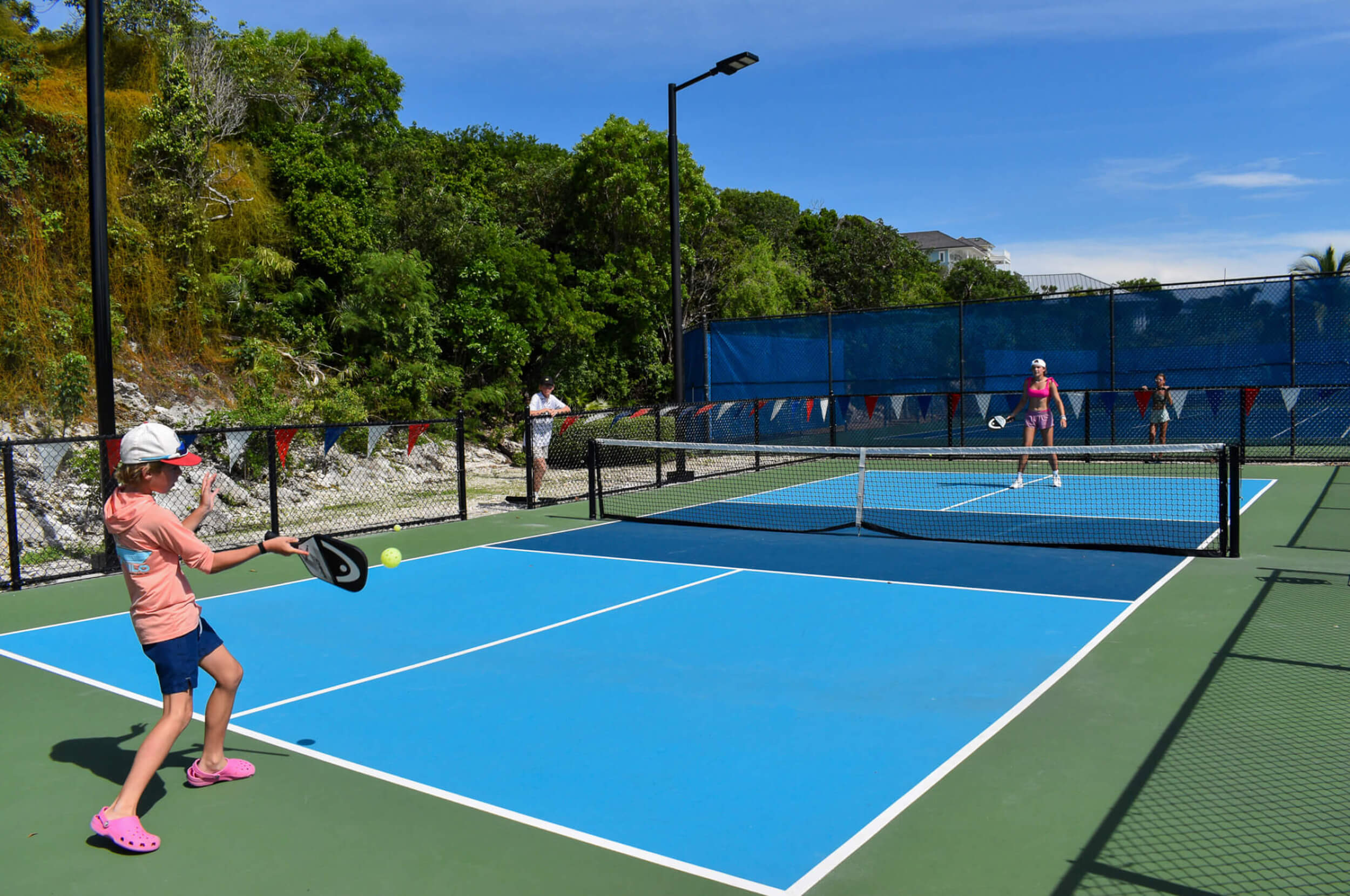Two people playing pickleball at The Abaco Club