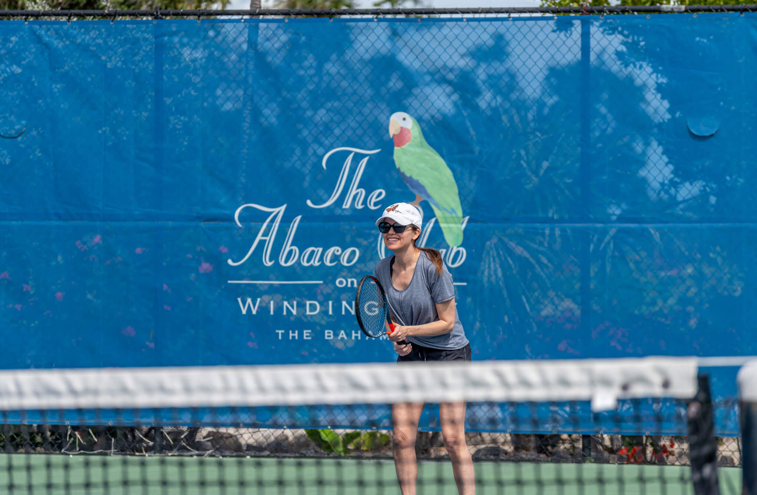 Woman playing tennis at The Abaco Club