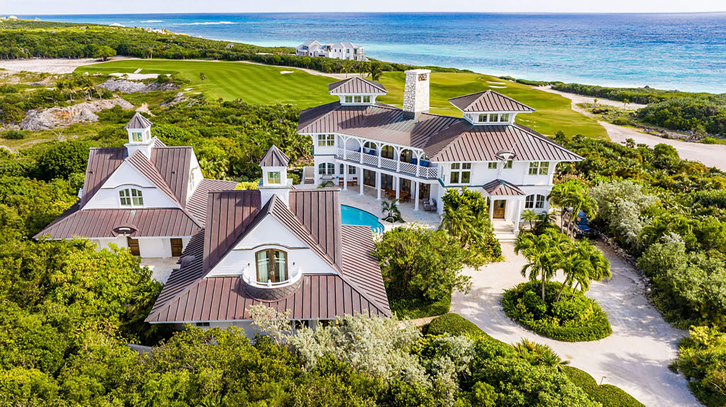 Aerial shot of the some of the beachfront houses at The Abaco Club with the Bahamian sea as a background