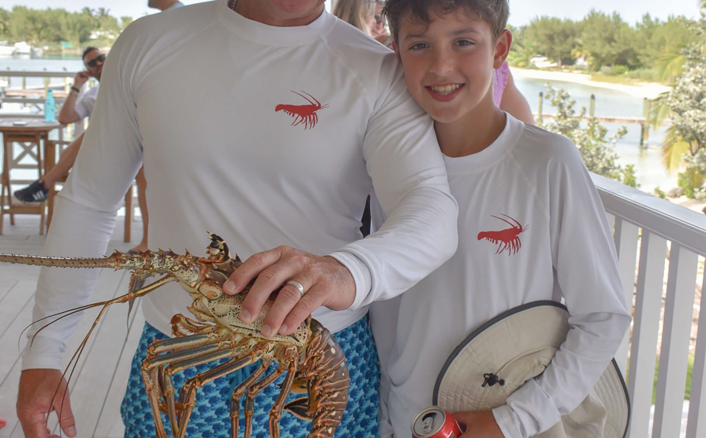 Father and son showing at a lobster fest at The Abaco Club