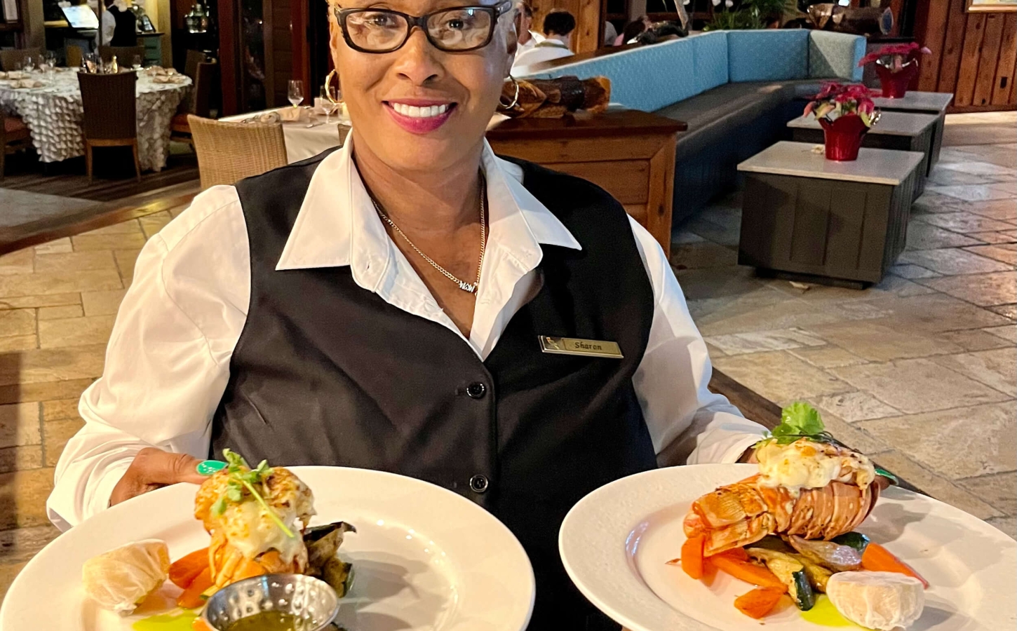 Friendly staff serving gourmet cuisine at The Abaco Club, reflecting the high standards of golf club hospitality and coastal living.