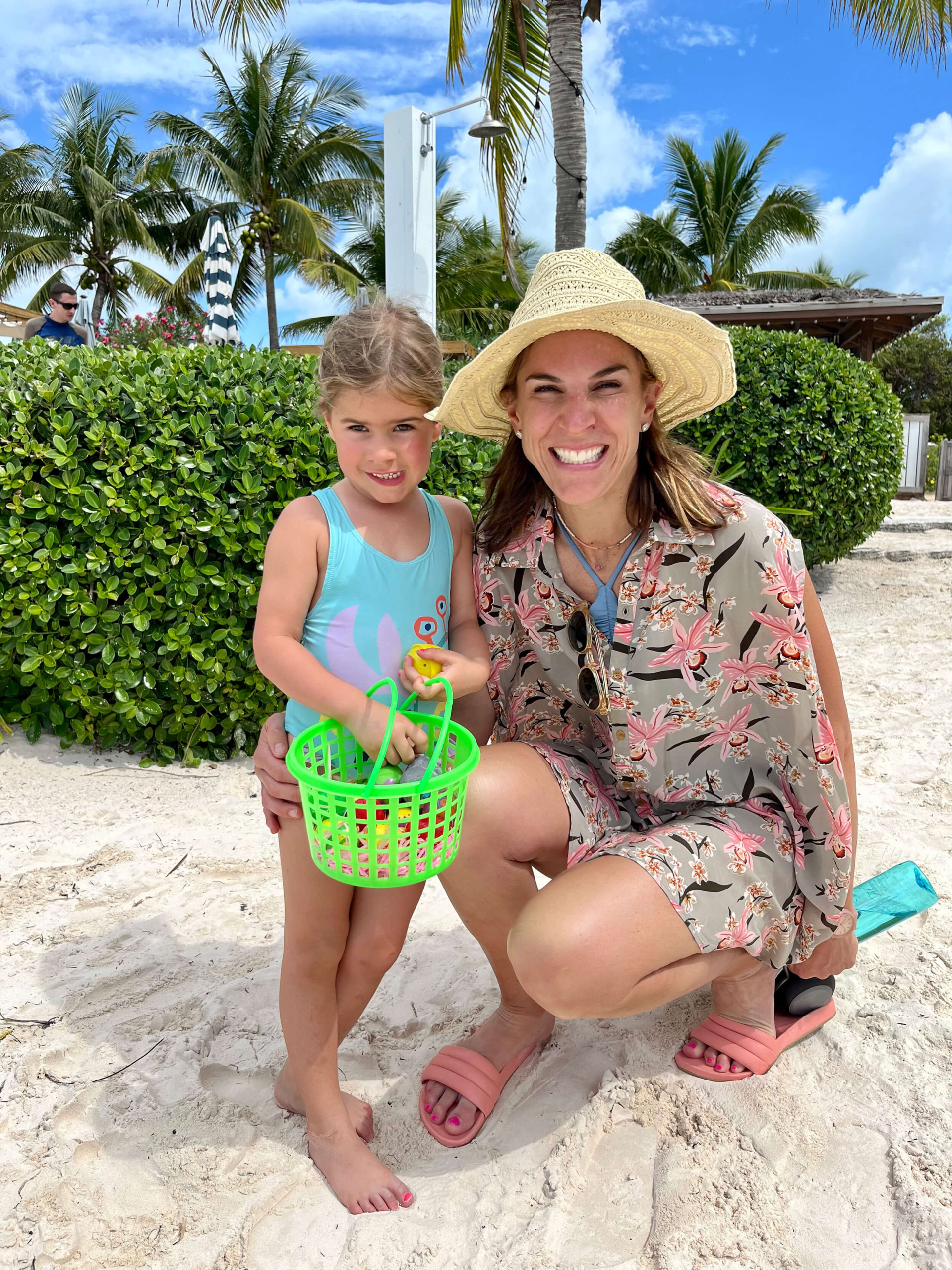 Young girl and woman with a beach bucket at The Abaco Club, showcasing the joy of coastal living