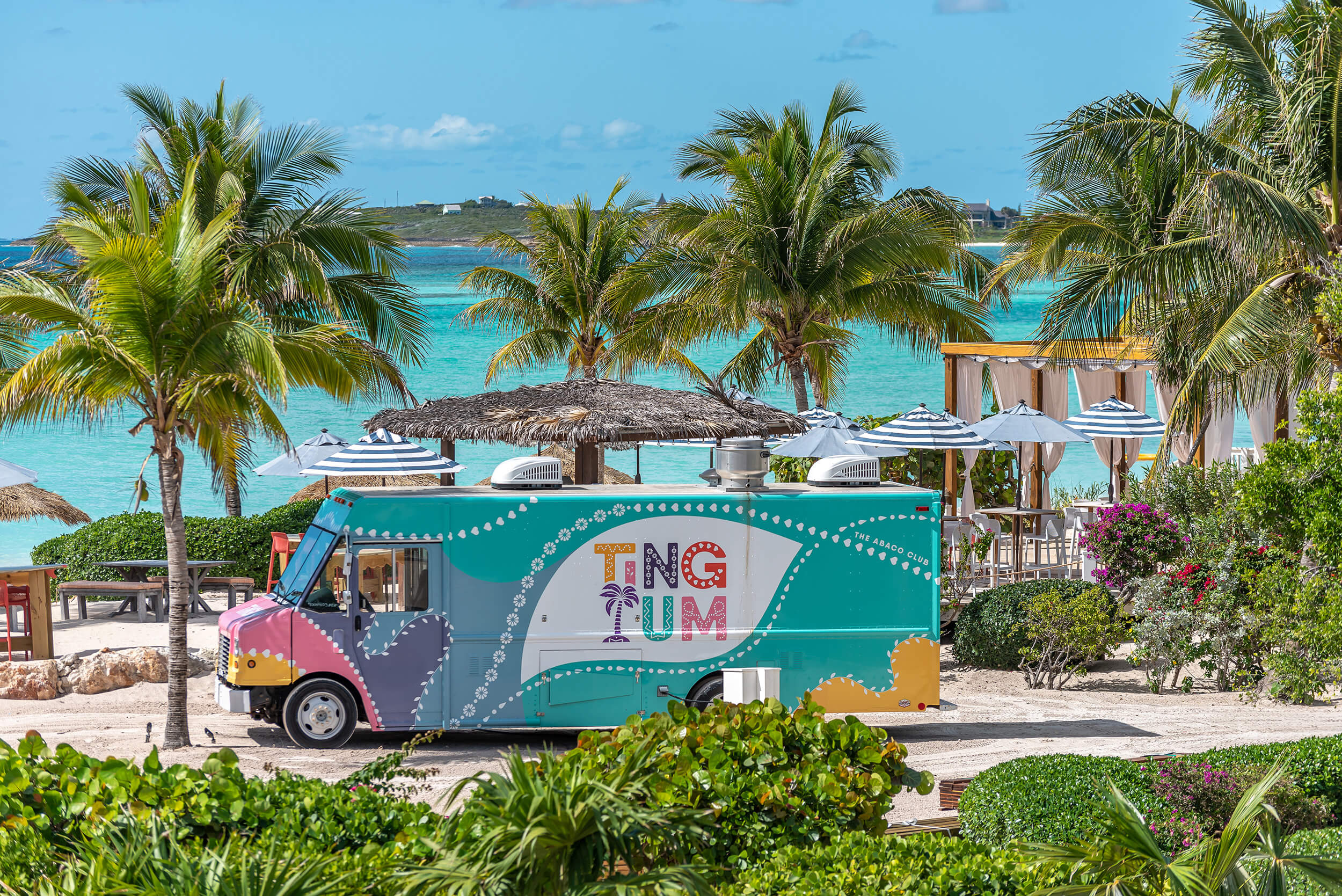 A colorful food truck parked on the beach at The Abaco Club's premier golf club