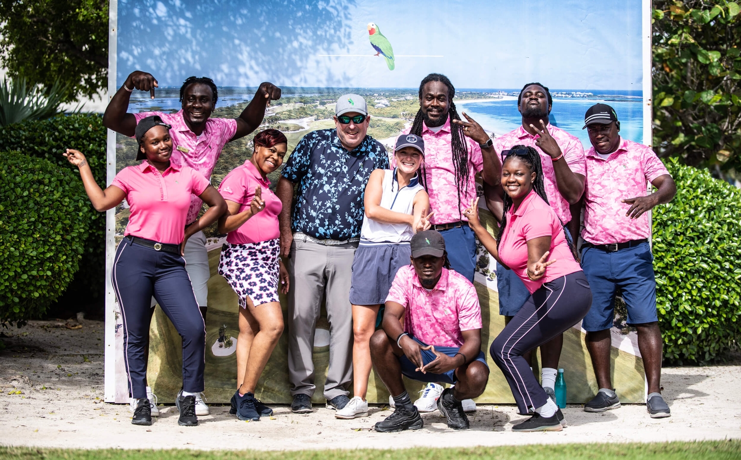 Energetic staff of The Abaco Club in pink uniforms, promoting the vibrant club lifestyle and coastal living