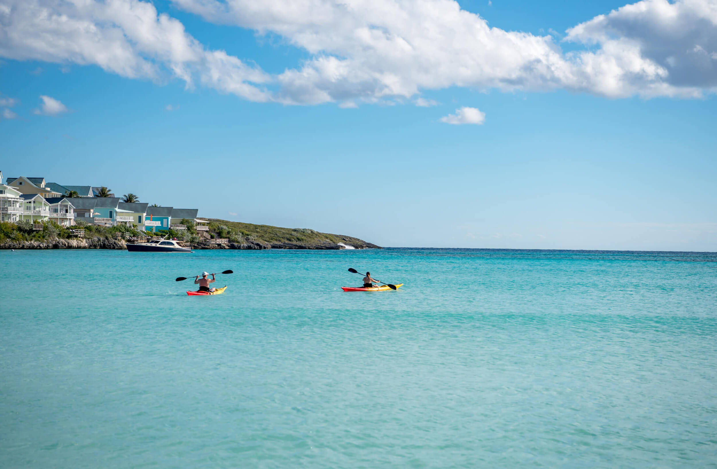 Kayakers exploring the calm waters near The Abaco Club, partaking in the active and scenic coastal club lifestyle