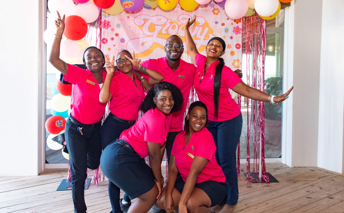 Vibrant team of The Abaco Club staff celebrating, highlighting the community spirit and cheerful coastal living in the Bahamas