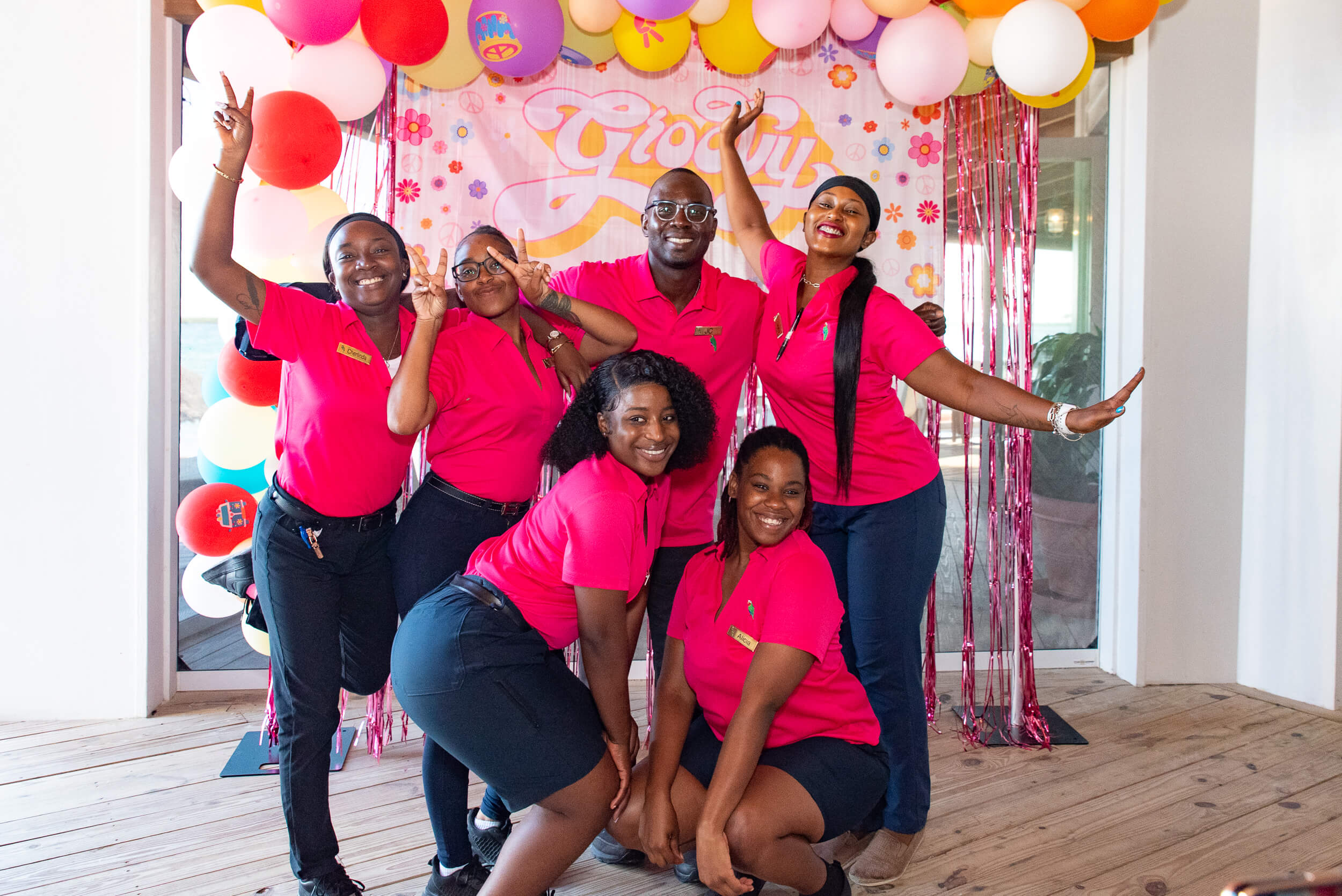 Vibrant team of The Abaco Club staff celebrating, highlighting the community spirit and cheerful coastal living in the Bahamas