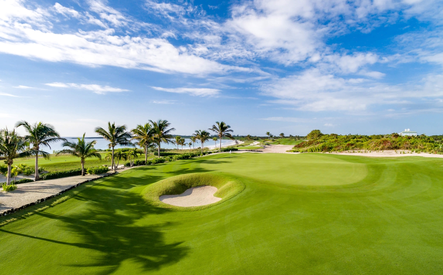 Pristine coastal scenery at The Abaco Club's 4th green, exemplifying a high-end golf club lifestyle