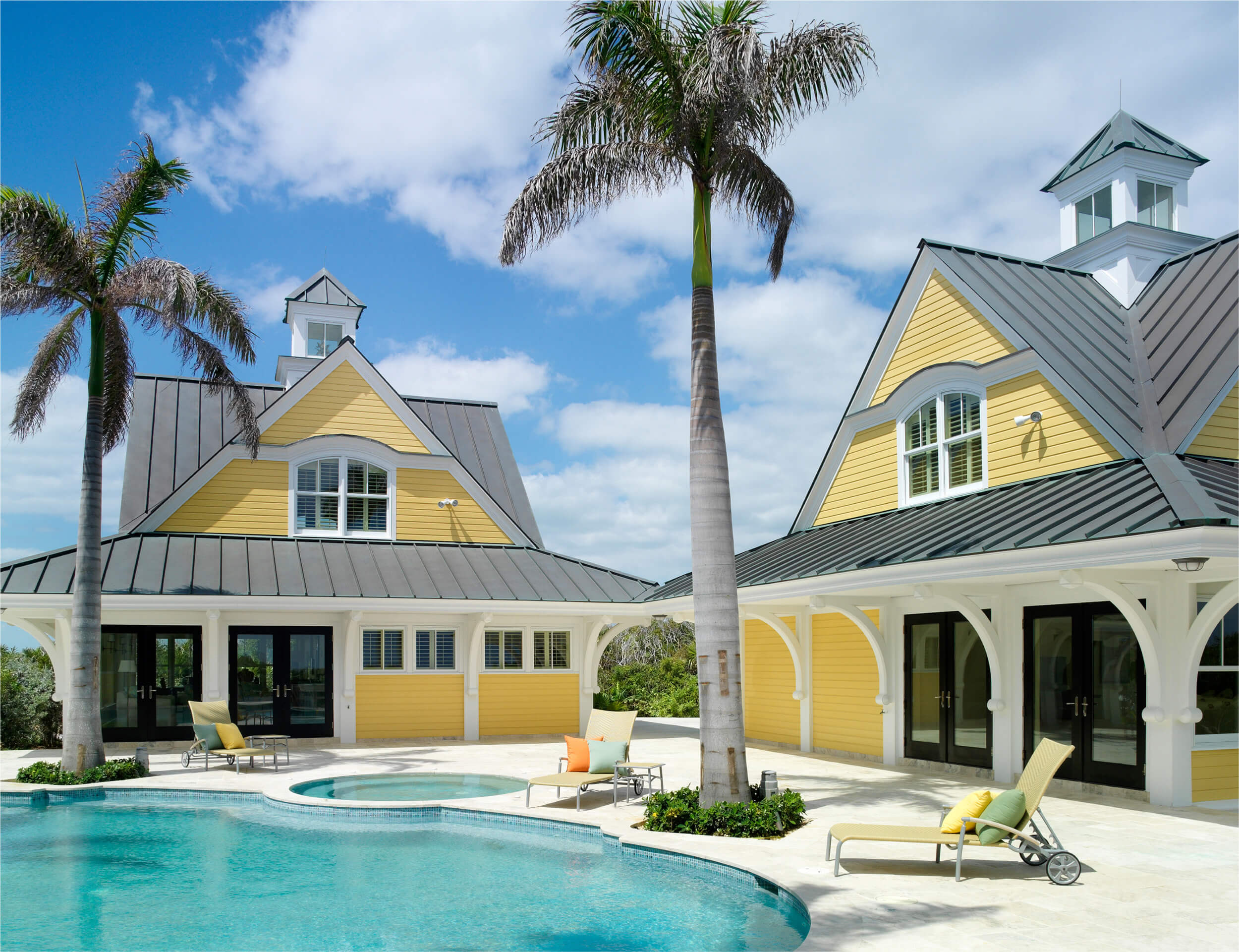 Elegant yellow coastal villa with a welcoming pool at The Abaco Club, reflecting the high-end club lifestyle in the serene environment of The Bahamas.