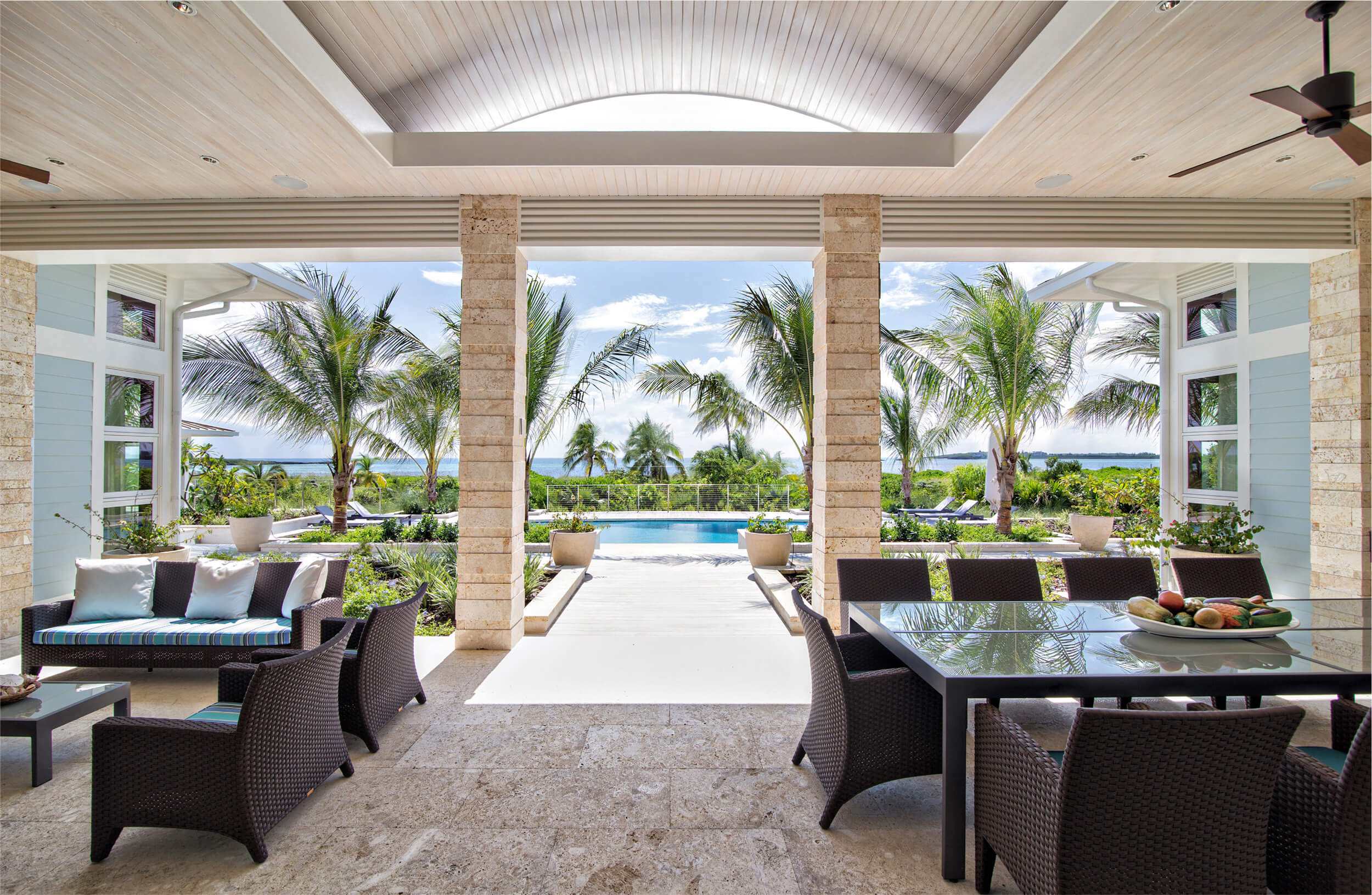 Sophisticated covered patio with modern wicker furniture at The Abaco Club, offering a blend of comfort and style for the ultimate club lifestyle in The Bahamas.