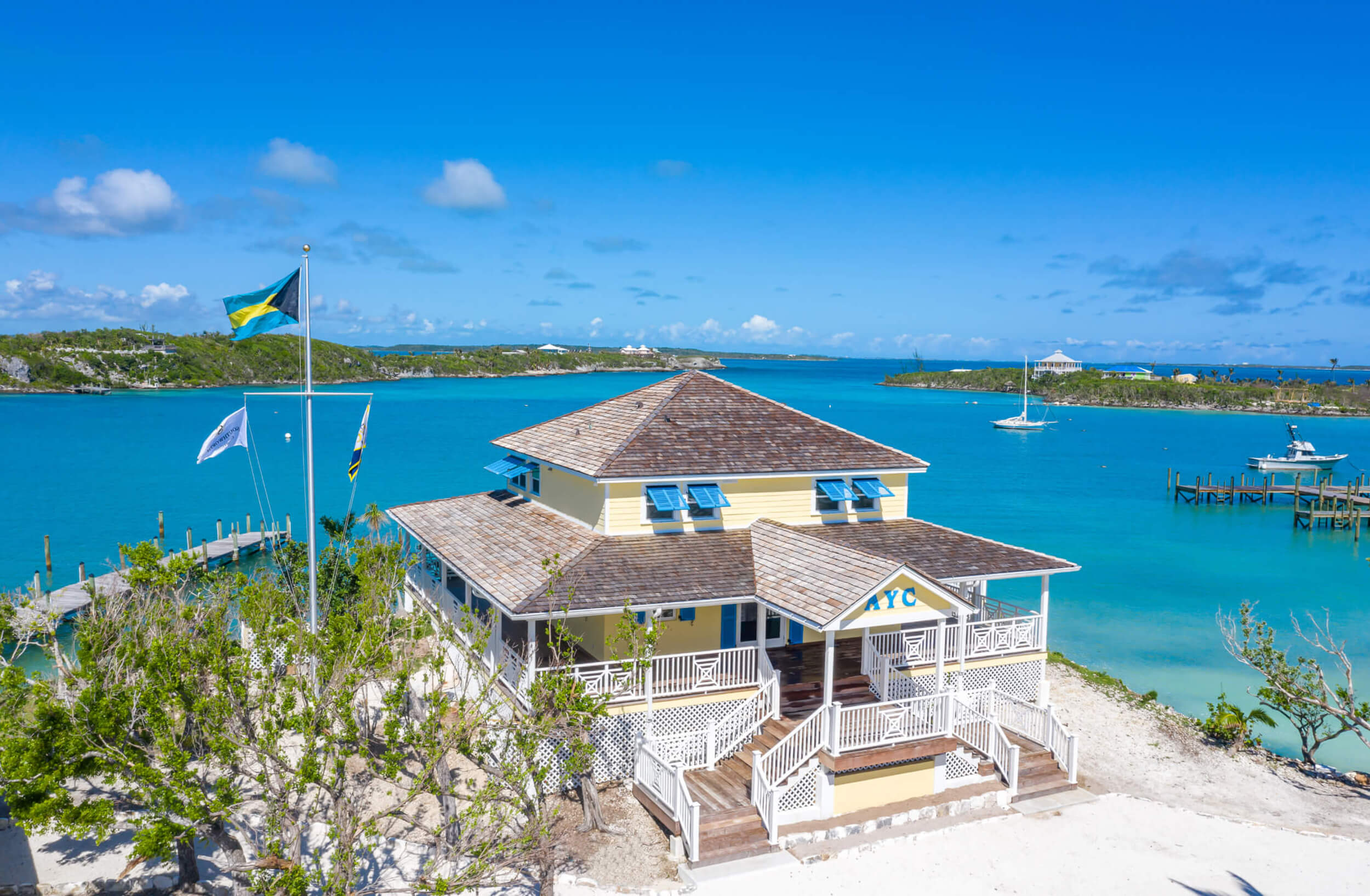 The Abaco yacht club and the crystal-clear Bahamian waters, highlighting exclusive club lifestyle.