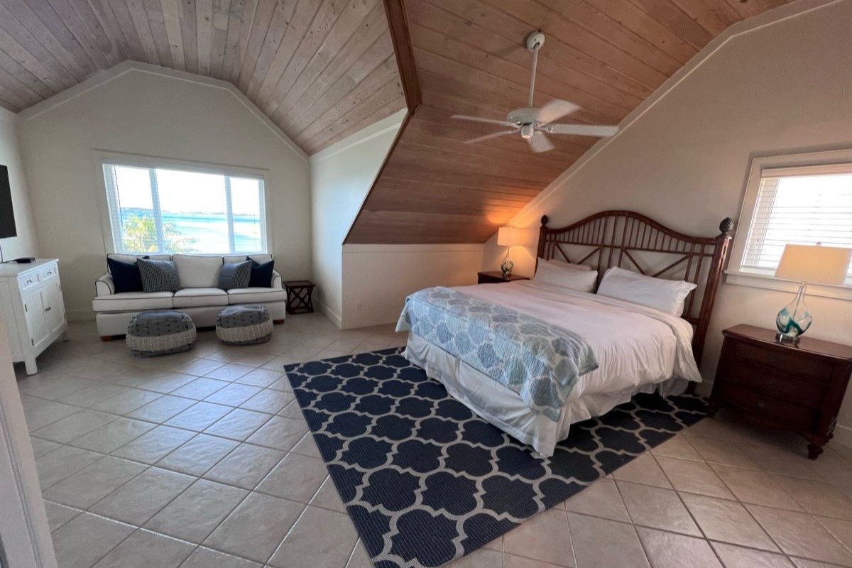 Cozy bedroom with an ocean view from a property in the Bahamas at The Abaco Club