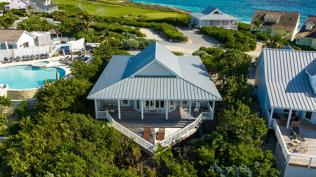 Scenic view of The Lookout a beachfront property at The Abaco Club with a golf green and the Bahamian ocean in the background.