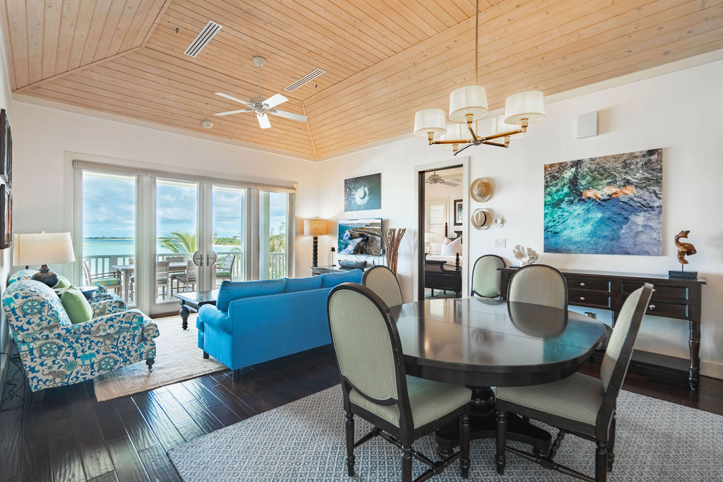 Living and dining room of a beach house with ocean view at The Abaco Club