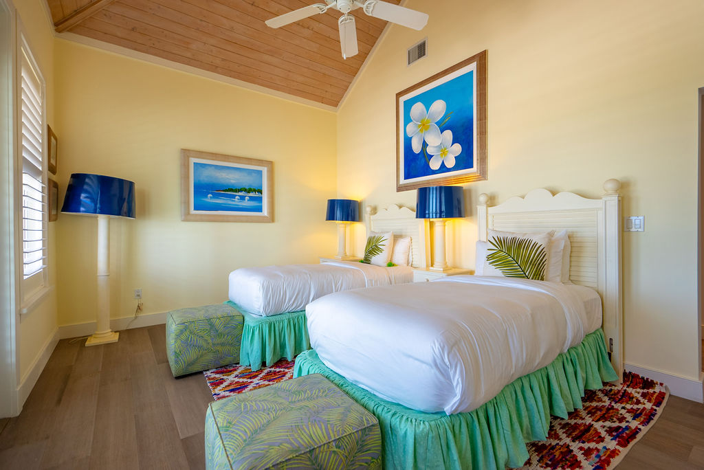 Elegant bedroom with twin beds and tropical decor at The Abaco Club