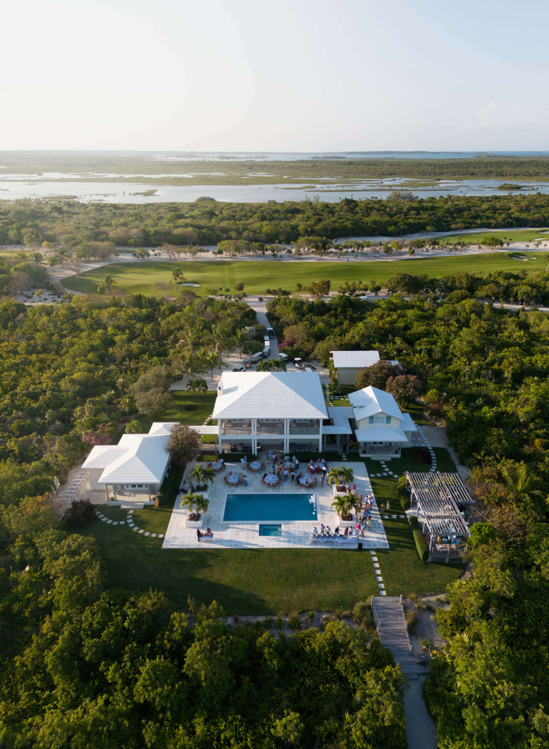 A serene aerial shot of The Abaco Club's resort-style pool and clubhouse, a paradise of coastal club living