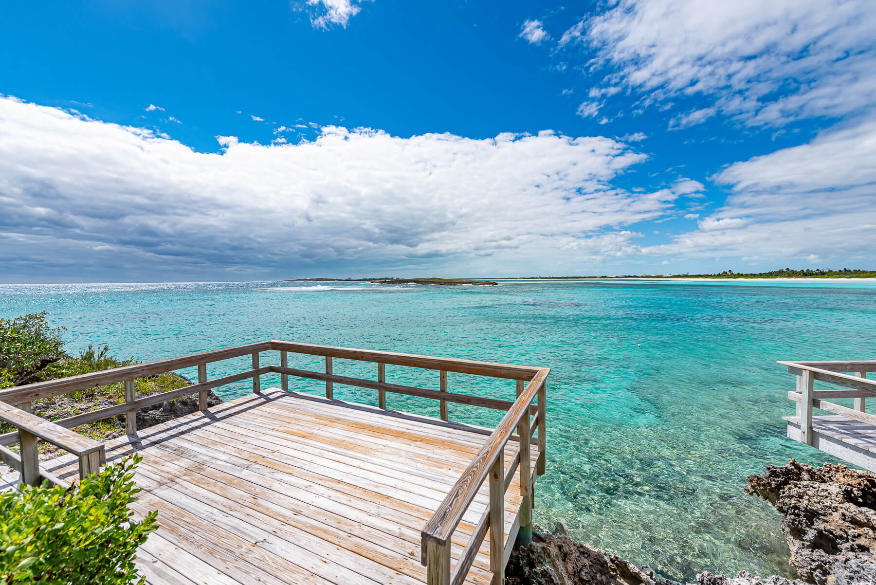 Scenic view from a property at The Abaco Club with ocean spray in the background and the natural beauty of the Bahamas