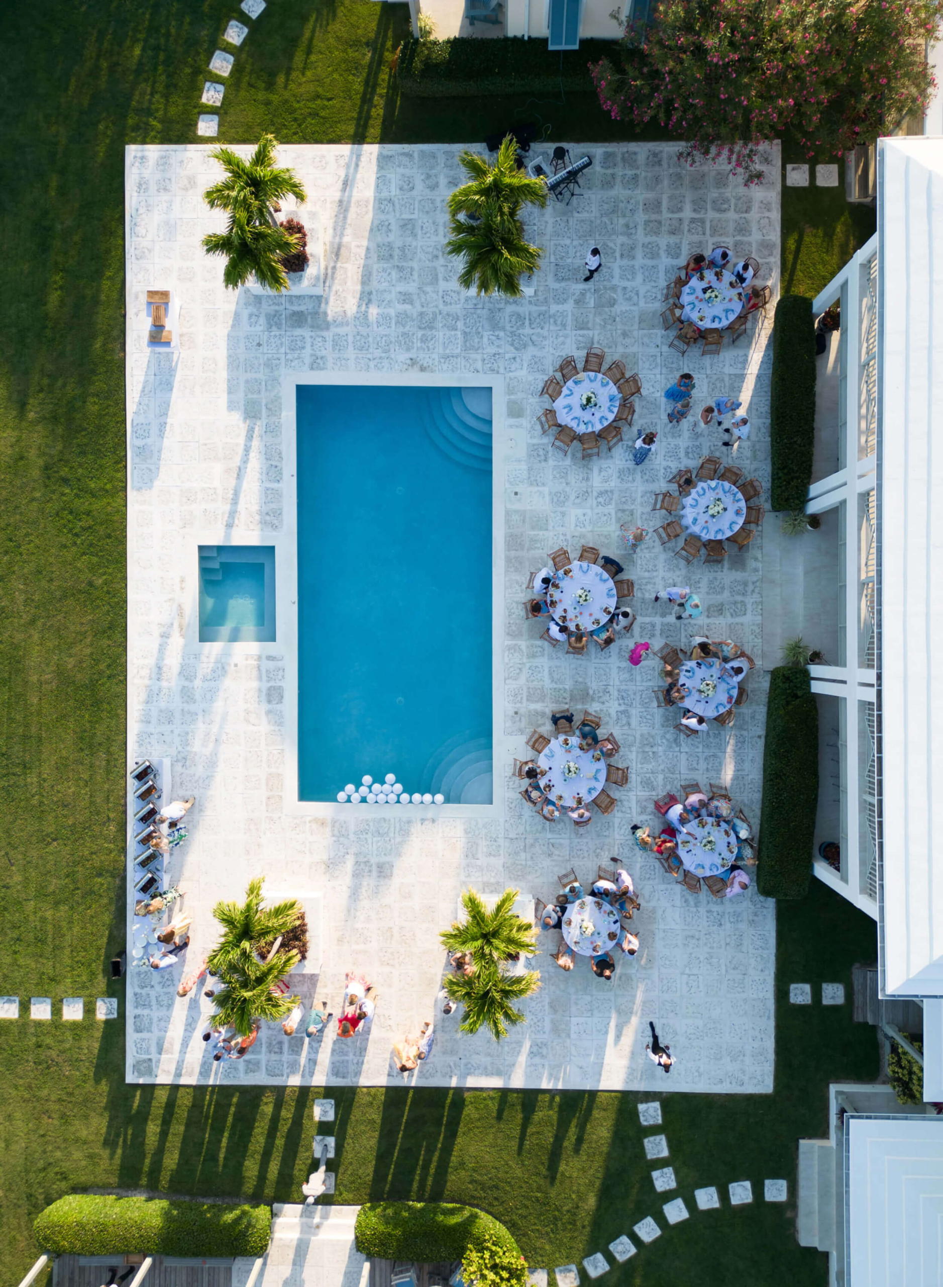 Overhead view of a social gathering at The Abaco Club poolside, epitomizing the club's luxurious coastal living