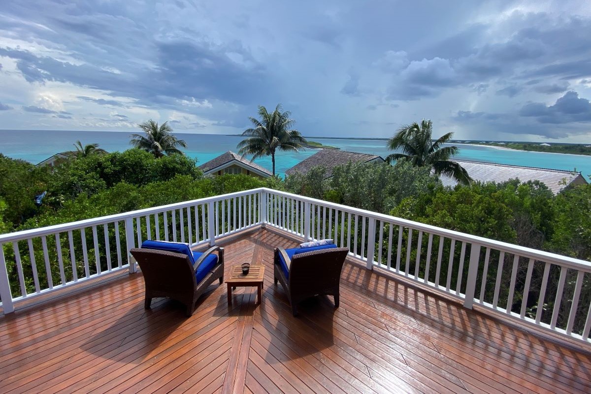 Balcony view and two blue chairs from a property in The Abaco Club