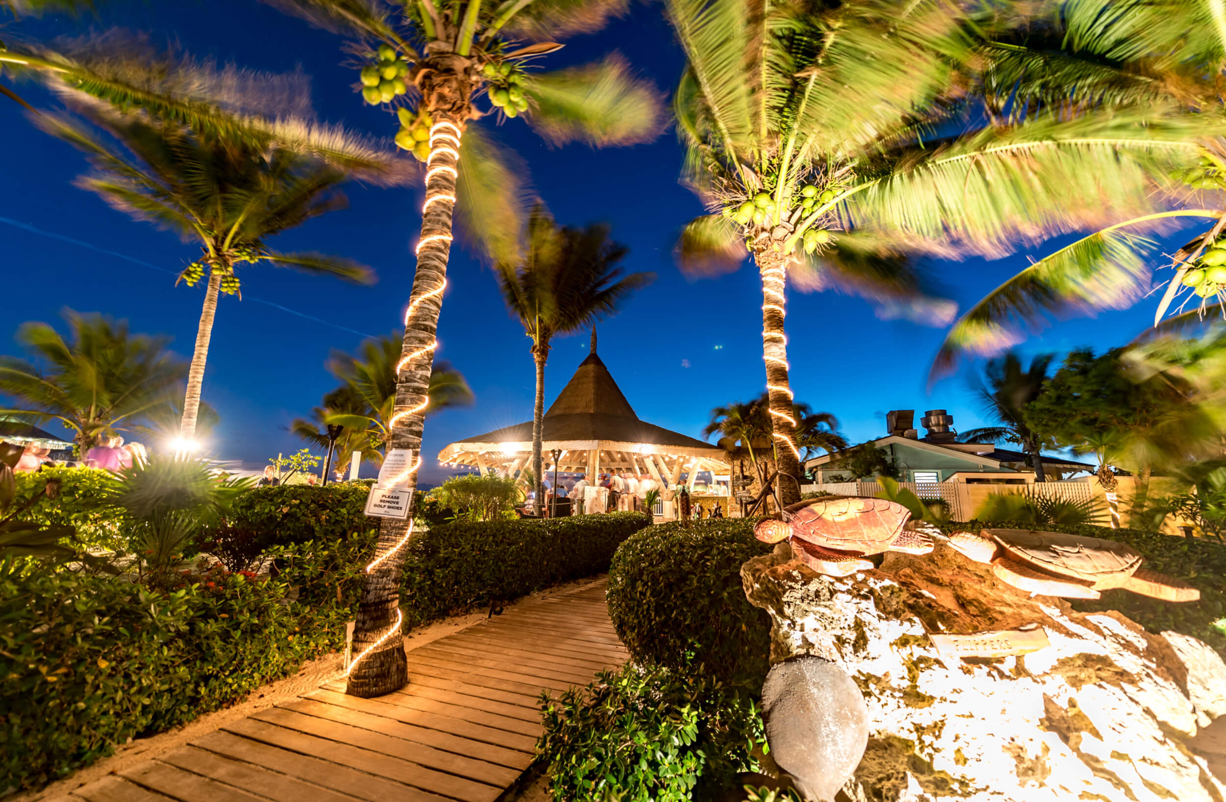 Twilight ambiance at The Abaco Club showcasing the vibrant club lifestyle with tropical landscaping.