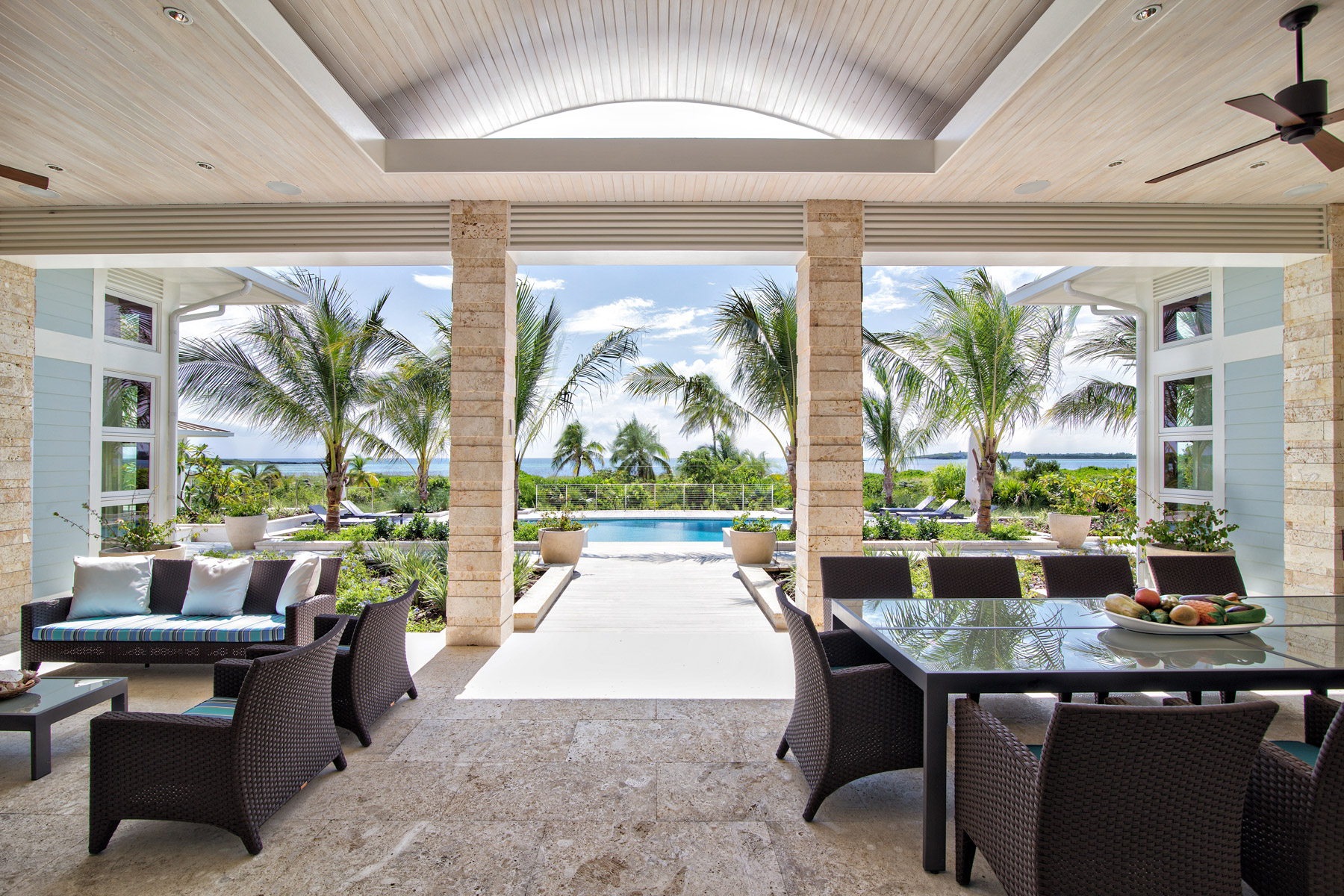 Living room and pool area of a house at The Abaco Club