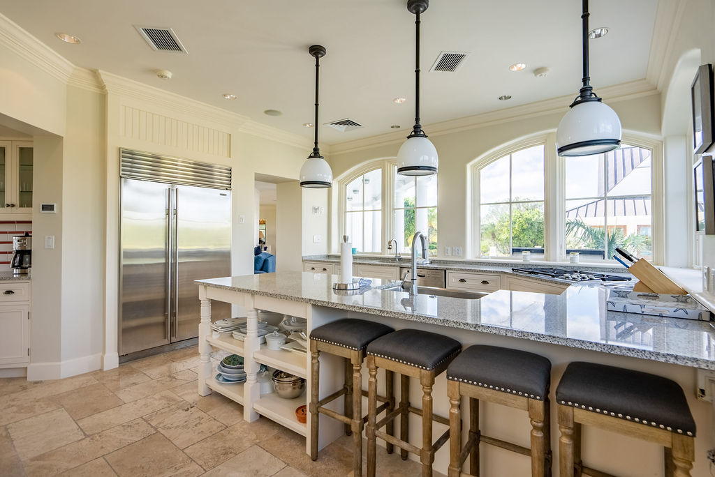 kitchen with stools at counter and sink in island top