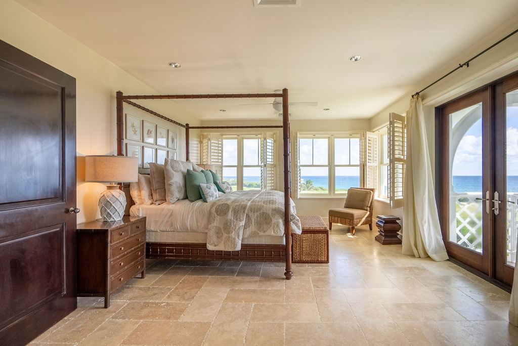 bed with canopy and view of the water in The Abaco Club
