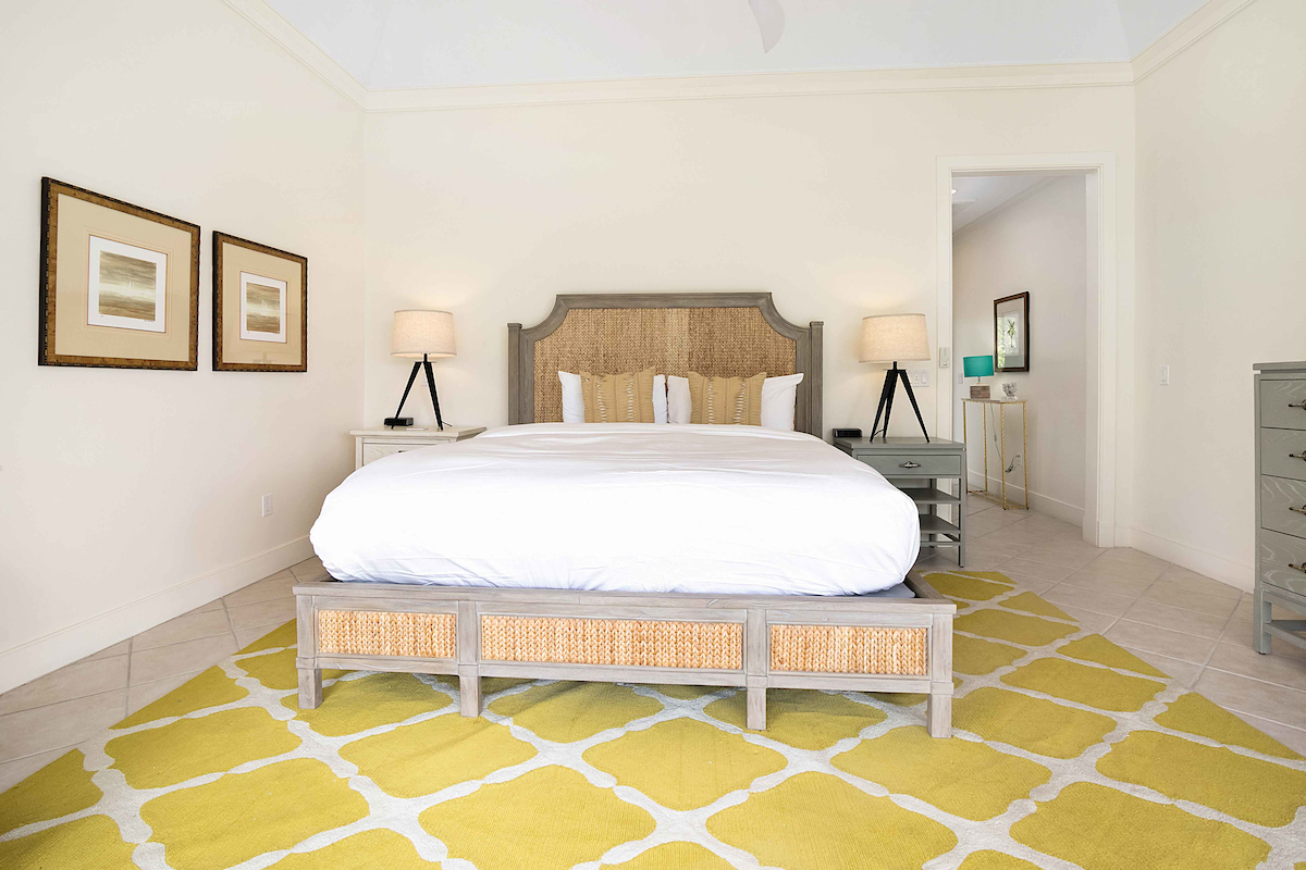 Bright and airy bedroom at The Abaco Club featuring golf club inspired interiors.