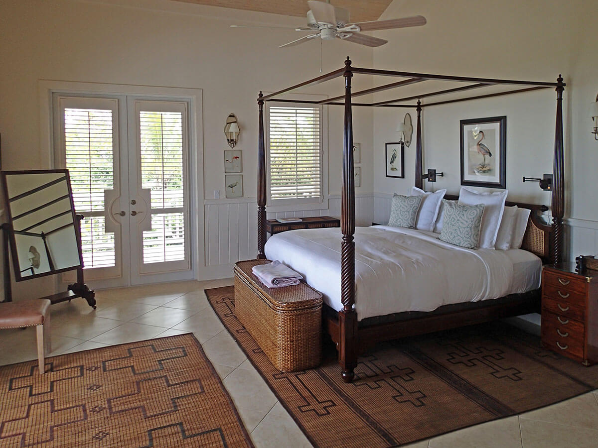 Luxurious four-poster bed in a spacious bedroom, highlighting the exclusive club lifestyle at The Abaco Club.