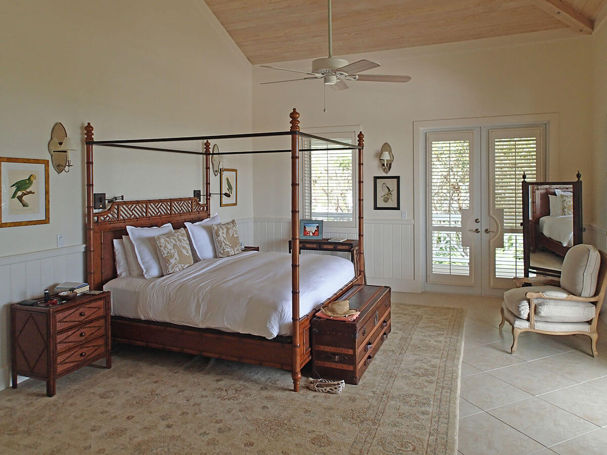 A four-poster bed in a spacious and airy bedroom, embodying the comfortable coastal living experience at The Abaco Club.