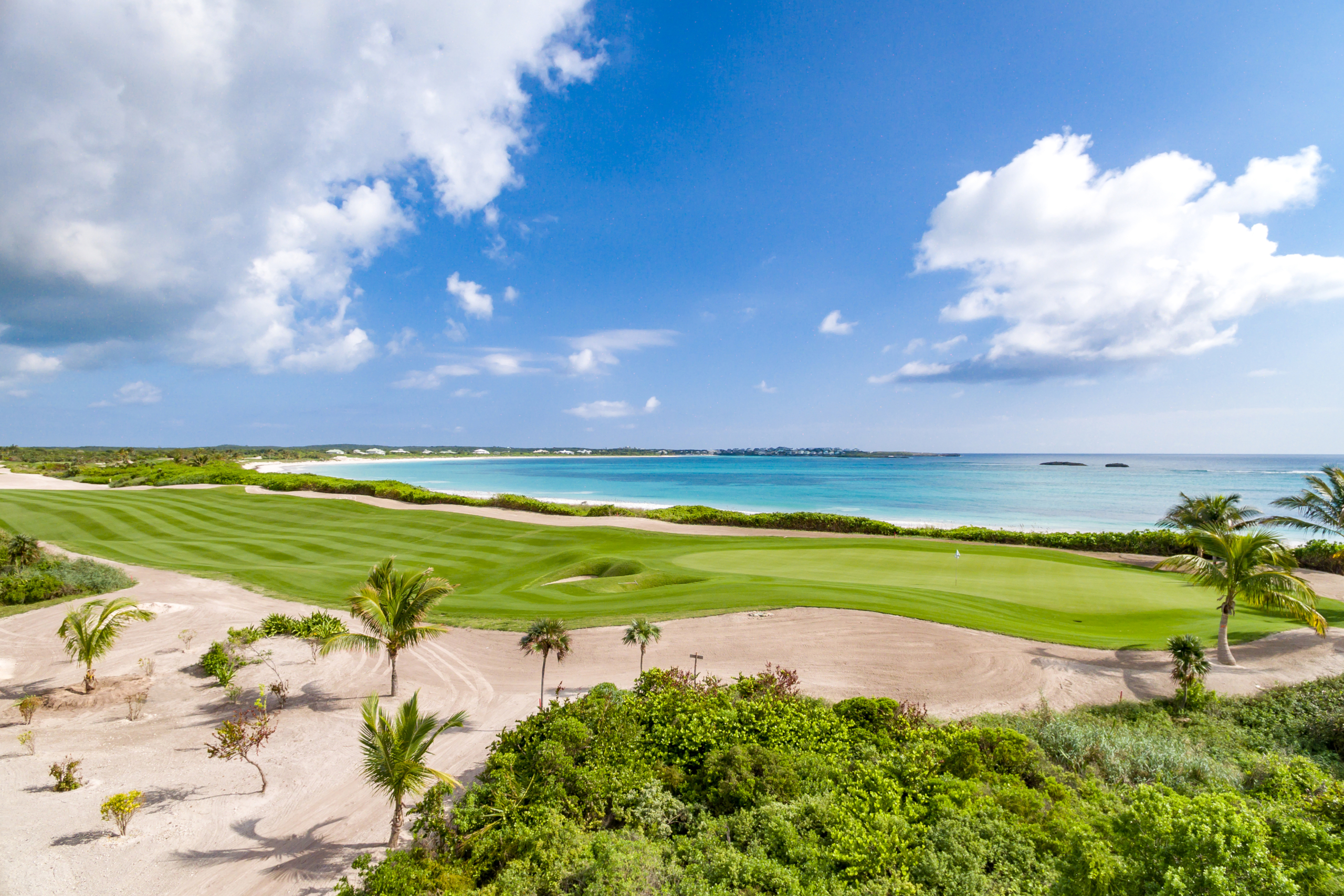 Aerial show of The Abaco Club 7th Green Fairway with a background of the Bahamian sea