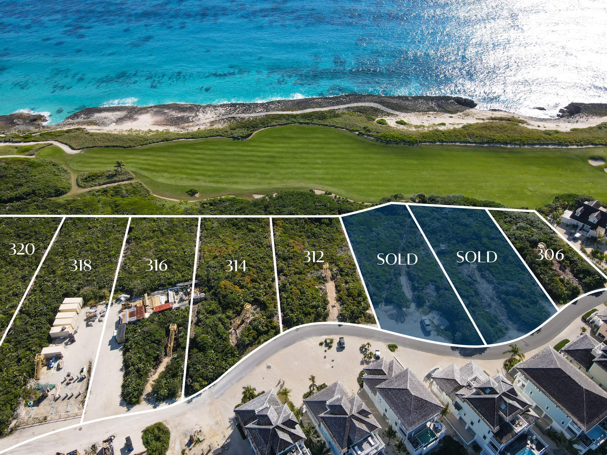 Aerial view of a coastal housing subdivision with numbered lots along a curved road, some marked SOLD, overlooking a turquoise sea and a green golf course beyond the shoreline.