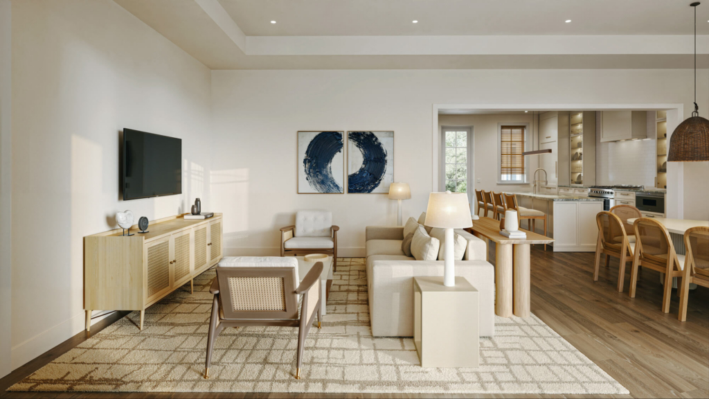 Open-concept living room with beige sofa, wood chairs, and a TV on a light wood console.