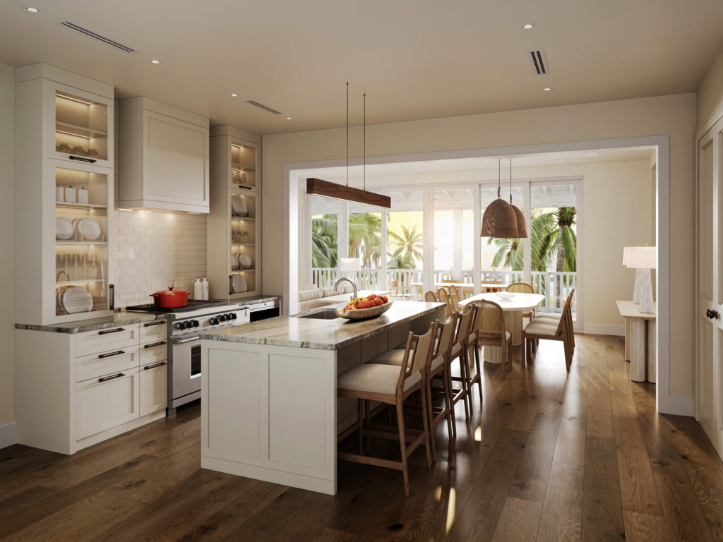 Bright open-concept kitchen with white cabinets, marble countertops, an island with stools, and a dining area by large windows overlooking a sunny patio with palm trees.